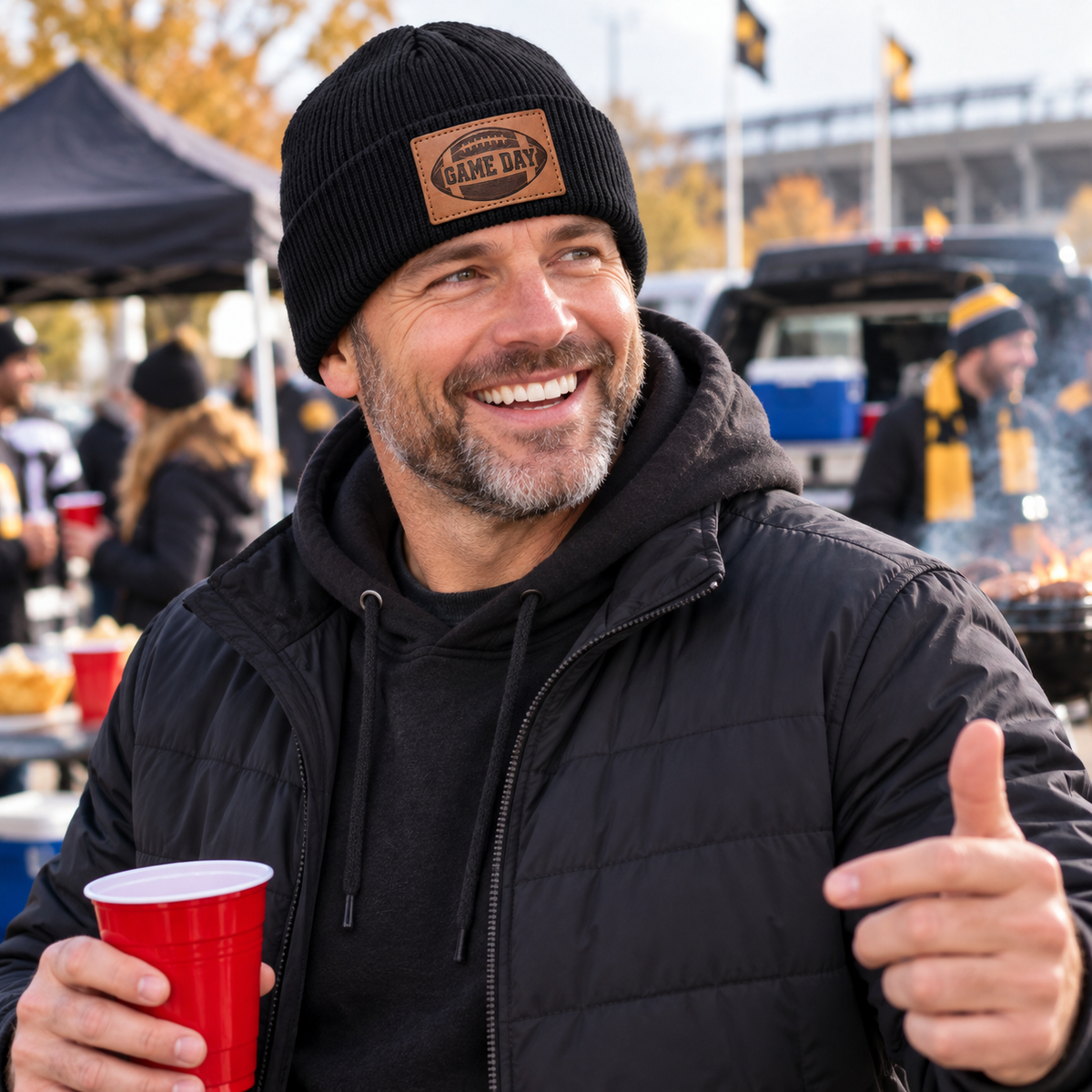 Man wearing black Game Day football engraved leather patch beanie
