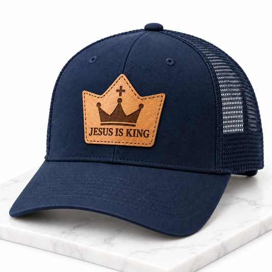 Jesus Is King leather patch trucker hat on white tile